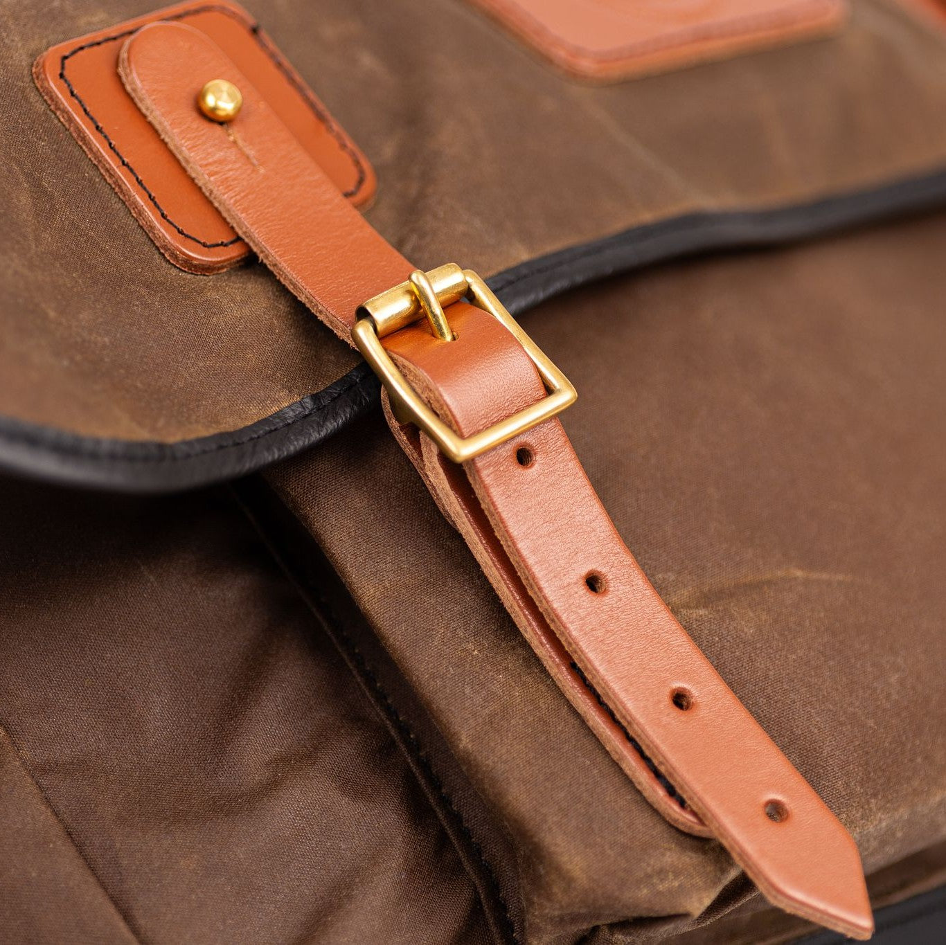 Gubbins messenger bag leather strap detail