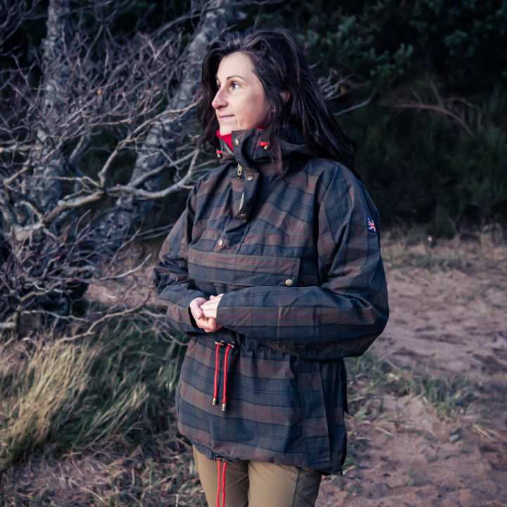 Woman wearing Tartan Skarbek smock looking out onto the Loch