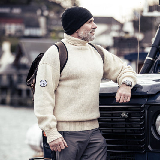 Man leaning on Land Rover wearing Trafalgar Sweater